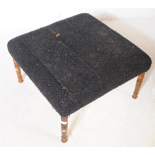 1051 - An early 20th Century square form black upholstery ottoman footstool upon turned oak legs. Measuring... 