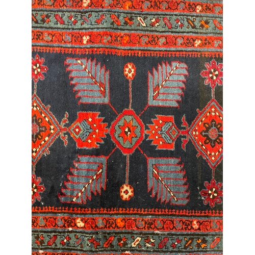 468 - An early 20th century Turkish Islamic floor carpet runner rug. The runner featuring floral fern styl... 