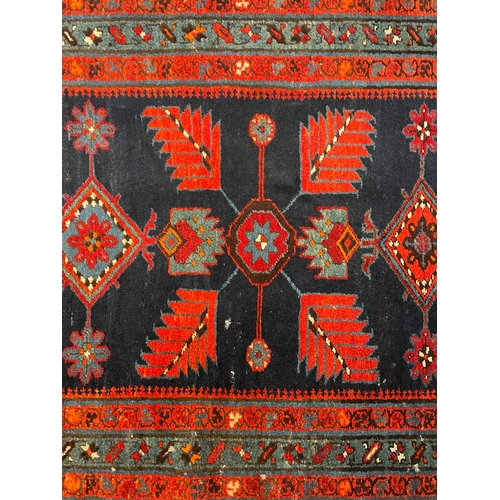 468 - An early 20th century Turkish Islamic floor carpet runner rug. The runner featuring floral fern styl... 