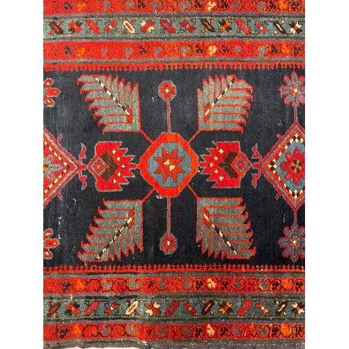 468 - An early 20th century Turkish Islamic floor carpet runner rug. The runner featuring floral fern styl... 