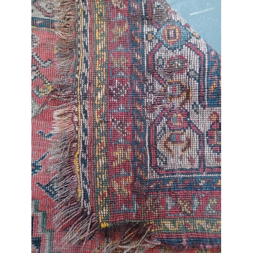 473 - A 19th century hand woven Persian Islamic Bidjar floor carpet rug. The rug having a central shaped m... 