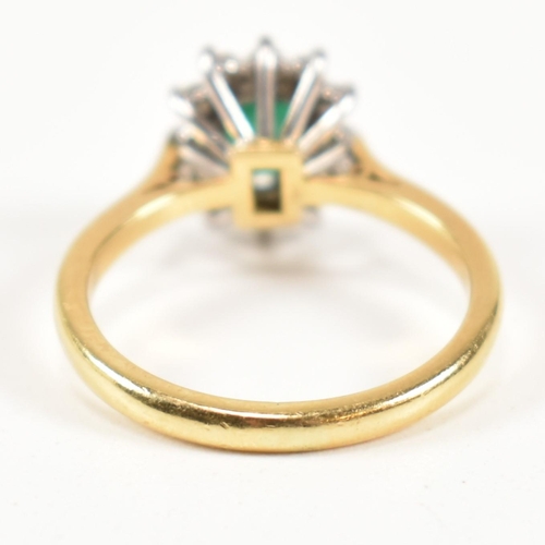 102 - A hallmarked 18ct gold, emerald and diamond cluster ring. The ring having a central emerald cut emer... 