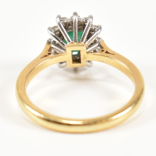 102 - A hallmarked 18ct gold, emerald and diamond cluster ring. The ring having a central emerald cut emer... 