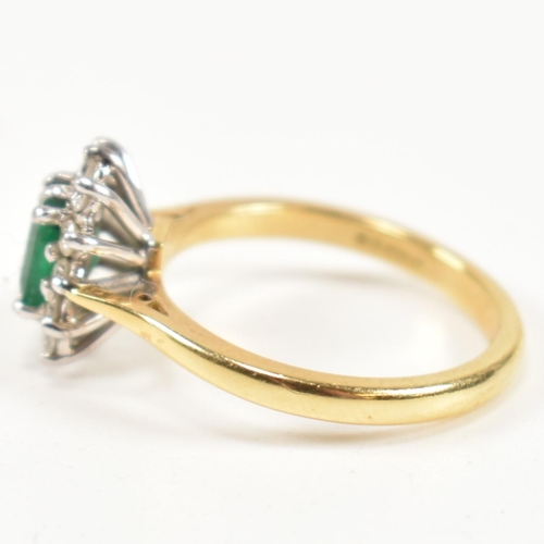 102 - A hallmarked 18ct gold, emerald and diamond cluster ring. The ring having a central emerald cut emer... 