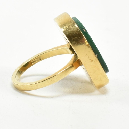 107 - A 1970s 18ct gold and malachite panel ring. The ring set with a malachite plaque. Stamped 18ct and S... 