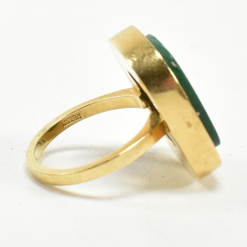 107 - A 1970s 18ct gold and malachite panel ring. The ring set with a malachite plaque. Stamped 18ct and S... 