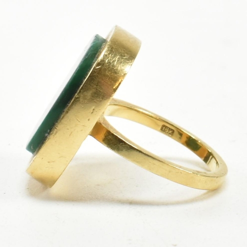 107 - A 1970s 18ct gold and malachite panel ring. The ring set with a malachite plaque. Stamped 18ct and S... 