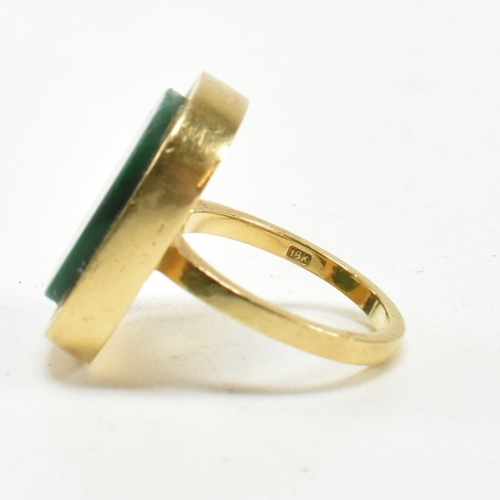 107 - A 1970s 18ct gold and malachite panel ring. The ring set with a malachite plaque. Stamped 18ct and S... 