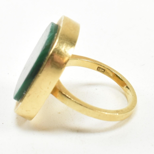 107 - A 1970s 18ct gold and malachite panel ring. The ring set with a malachite plaque. Stamped 18ct and S... 