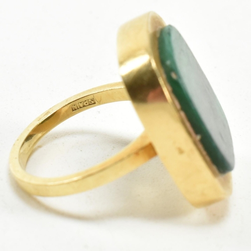 107 - A 1970s 18ct gold and malachite panel ring. The ring set with a malachite plaque. Stamped 18ct and S... 