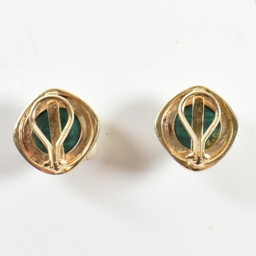 109 - A pair of 18ct gold and malachite ear clips. The earrings having round bezel mounted malachite caboc... 