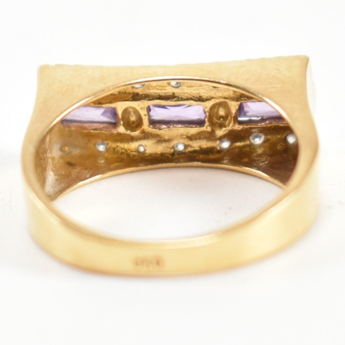 110 - An 18ct gold, amethyst and diamond ring. The ring set with a central row of three east-west baguette... 