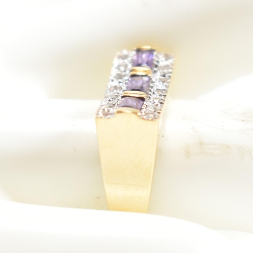 110 - An 18ct gold, amethyst and diamond ring. The ring set with a central row of three east-west baguette... 