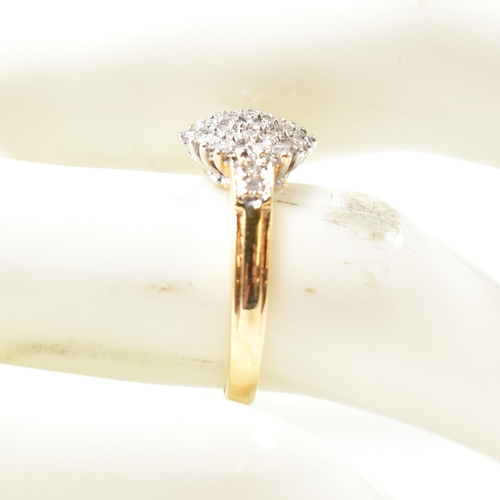 113 - A hallmarked 18ct gold and diamond cluster ring. The ring having a hexagonal shape cluster of round ... 