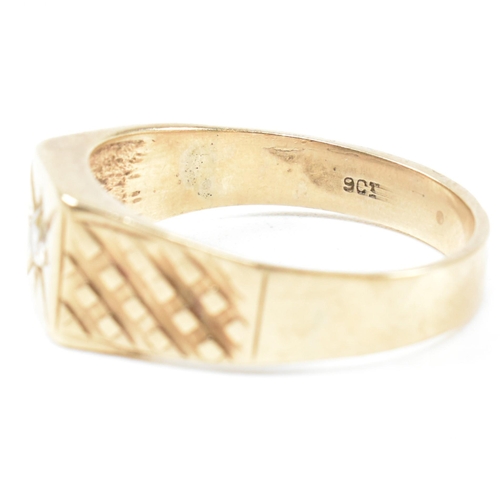 117 - A 9ct gold and gem set signet ring. The ring set with a single white spinel and having stylized shou... 