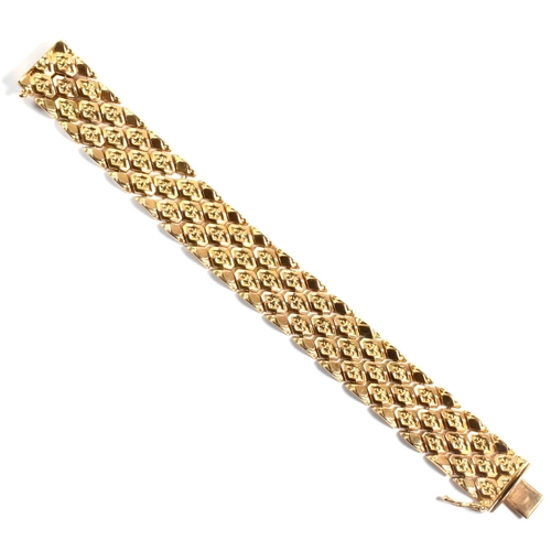 12 - An Italian 18ct gold bracelet. The bracelet formed with textured flower decorated diamond links to t... 