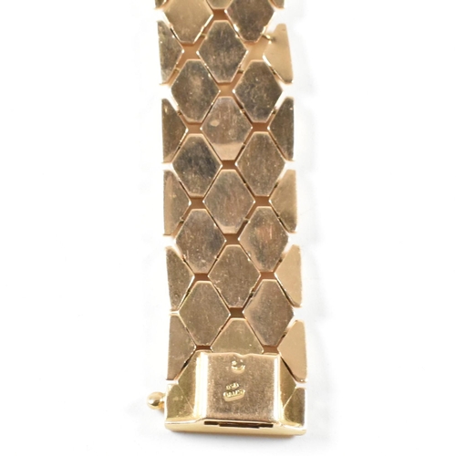 12 - An Italian 18ct gold bracelet. The bracelet formed with textured flower decorated diamond links to t... 