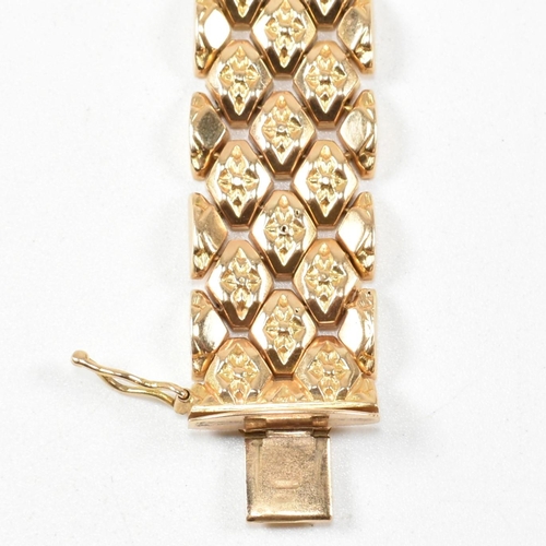 12 - An Italian 18ct gold bracelet. The bracelet formed with textured flower decorated diamond links to t... 