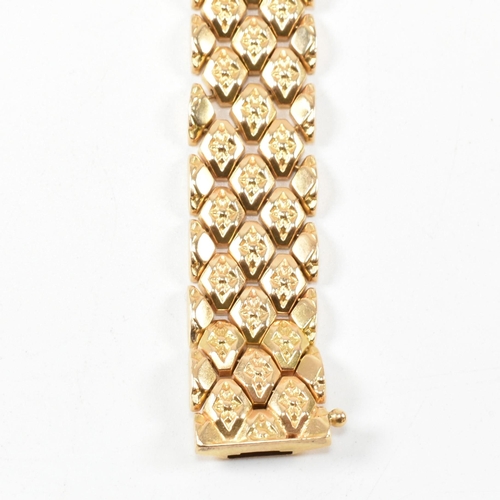 12 - An Italian 18ct gold bracelet. The bracelet formed with textured flower decorated diamond links to t... 