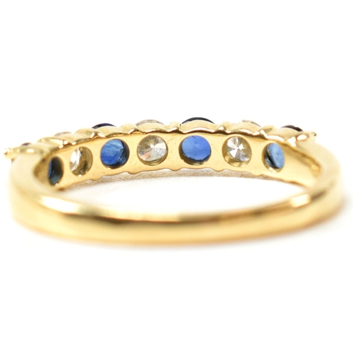 127 - A hallmarked 18ct gold, sapphire and diamond half hoop ring. The ring having four shared claw set ro... 