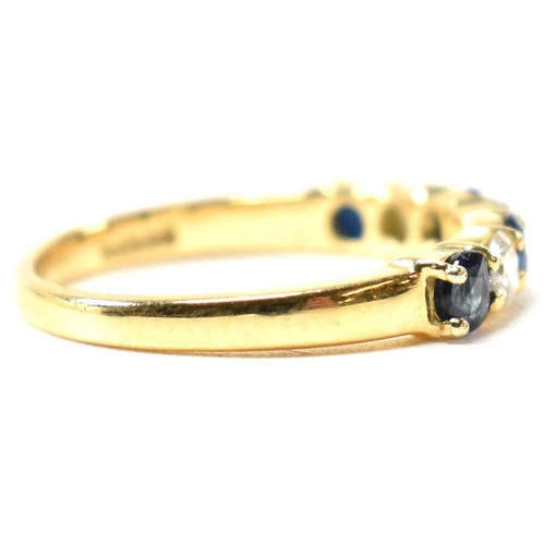 127 - A hallmarked 18ct gold, sapphire and diamond half hoop ring. The ring having four shared claw set ro... 