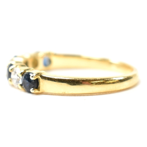 127 - A hallmarked 18ct gold, sapphire and diamond half hoop ring. The ring having four shared claw set ro... 