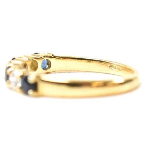 127 - A hallmarked 18ct gold, sapphire and diamond half hoop ring. The ring having four shared claw set ro... 