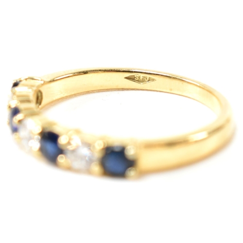 127 - A hallmarked 18ct gold, sapphire and diamond half hoop ring. The ring having four shared claw set ro... 