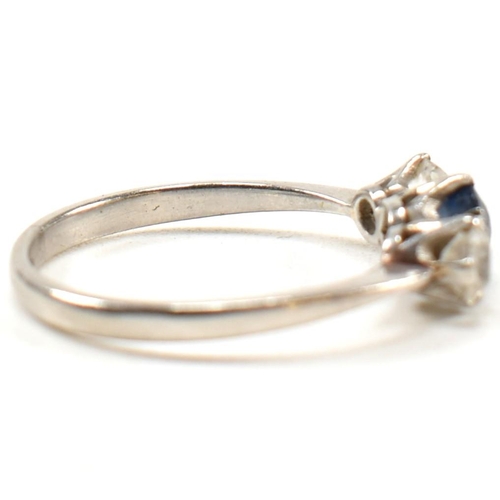 129 - A platinum, sapphire and diamond three stone ring. The platinum trilogy ring having a central round ... 