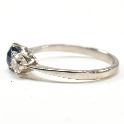 129 - A platinum, sapphire and diamond three stone ring. The platinum trilogy ring having a central round ... 