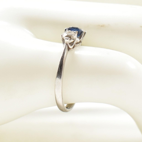 129 - A platinum, sapphire and diamond three stone ring. The platinum trilogy ring having a central round ... 