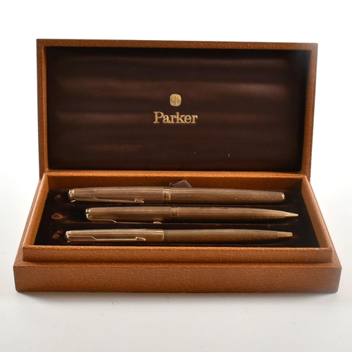 13 - Cased set of three hallmarked 9ct gold Parker pens. The pens to include a fountain pen, ball point p... 