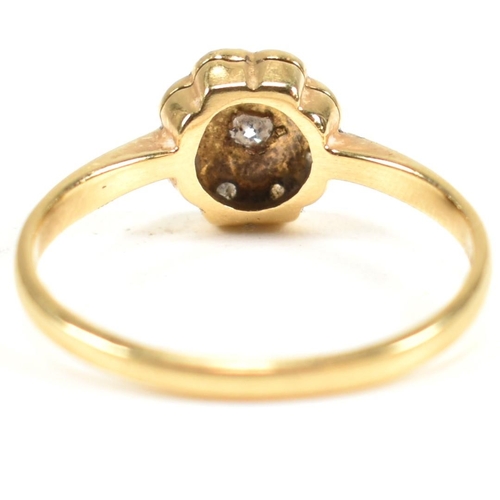 131 - An 18ct gold and diamond cluster ring. The ring set with a central round cut diamond surrounded by a... 