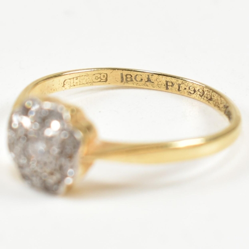 131 - An 18ct gold and diamond cluster ring. The ring set with a central round cut diamond surrounded by a... 