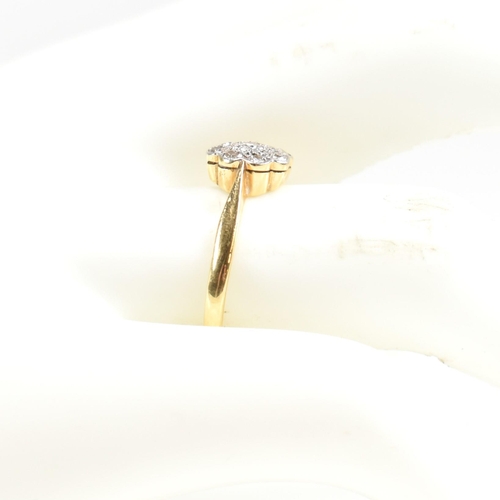 131 - An 18ct gold and diamond cluster ring. The ring set with a central round cut diamond surrounded by a... 