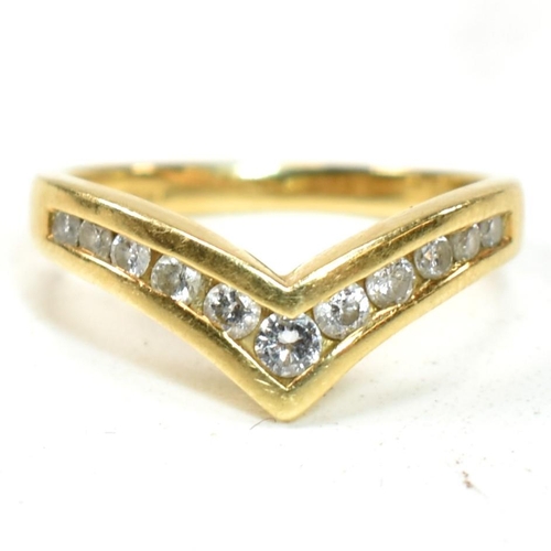 133 - A hallmarked 18ct gold and diamond wishbone ring. The 18ct gold wishbone ring having eleven channel ... 