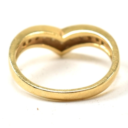 133 - A hallmarked 18ct gold and diamond wishbone ring. The 18ct gold wishbone ring having eleven channel ... 