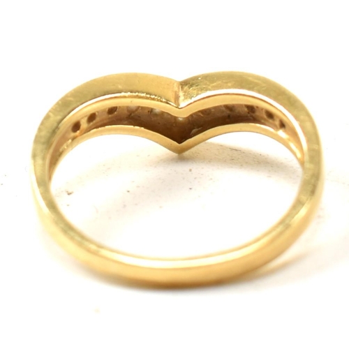 133 - A hallmarked 18ct gold and diamond wishbone ring. The 18ct gold wishbone ring having eleven channel ... 