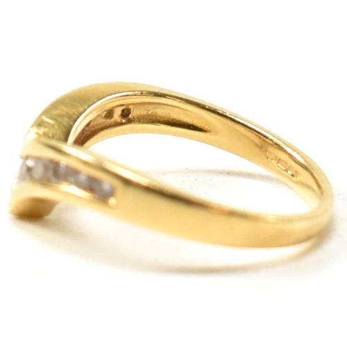 133 - A hallmarked 18ct gold and diamond wishbone ring. The 18ct gold wishbone ring having eleven channel ... 