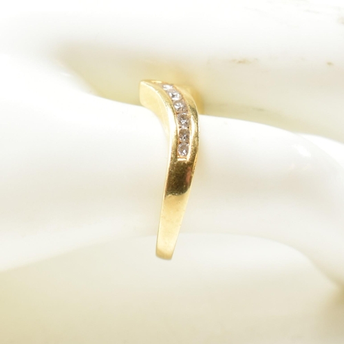 133 - A hallmarked 18ct gold and diamond wishbone ring. The 18ct gold wishbone ring having eleven channel ... 