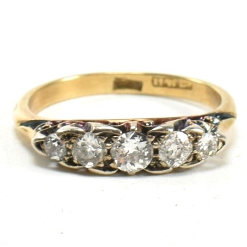 14 - An 18ct gold and diamond five stone ring. The ring set with five old cut diamonds to a scrolled gall... 