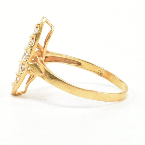 142 - A high carat gold and gem set ring. The ring set with white stones to a navette mount. Marked 835. T... 