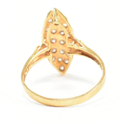 142 - A high carat gold and gem set ring. The ring set with white stones to a navette mount. Marked 835. T... 