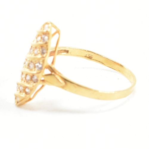 142 - A high carat gold and gem set ring. The ring set with white stones to a navette mount. Marked 835. T... 