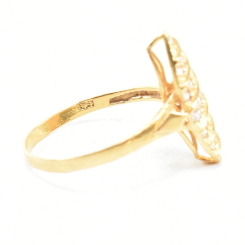 142 - A high carat gold and gem set ring. The ring set with white stones to a navette mount. Marked 835. T... 