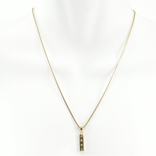 146 - An 18ct gold, emerald and diamond pendant necklace. The 18ct gold snake chain necklace strung with a... 