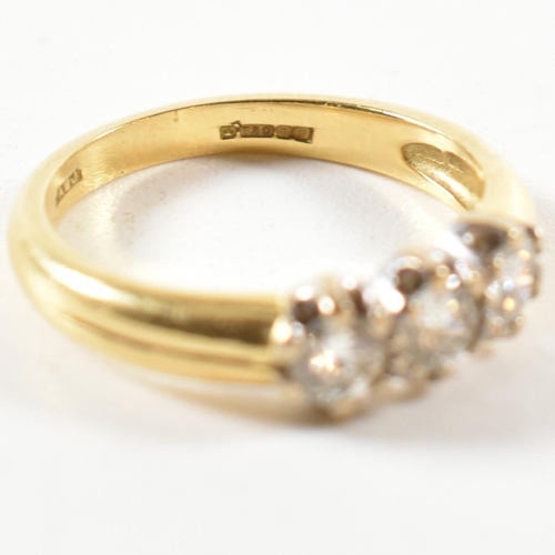 147 - A hallmarked 18ct gold and diamond trilogy ring. The ring three round cut diamonds set in a white go... 