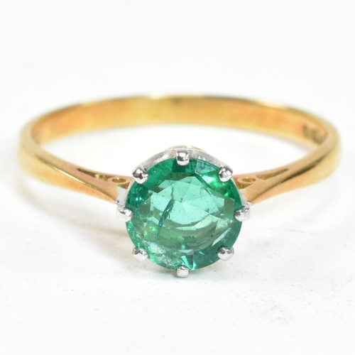 15 - A hallmarked 18ct gold and emerald solitaire ring. The ring set with a round mixed cut emerald. Hall... 