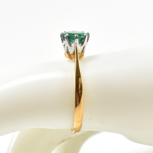 15 - A hallmarked 18ct gold and emerald solitaire ring. The ring set with a round mixed cut emerald. Hall... 