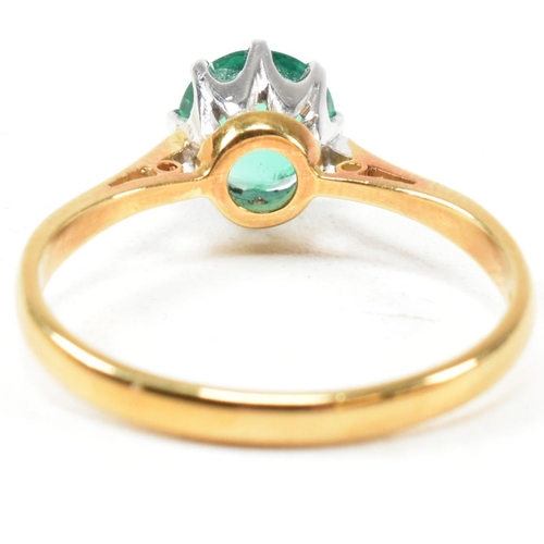 15 - A hallmarked 18ct gold and emerald solitaire ring. The ring set with a round mixed cut emerald. Hall... 